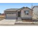 Charming single-Gathering home featuring stone accents, a two-car garage, and a well-maintained front yard at 22036 E 39Th Pl, Aurora, CO 80019