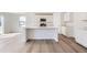 Modern kitchen featuring stainless steel appliances, white cabinets, quartz countertop, and a breakfast bar at 22036 E 39Th Pl, Aurora, CO 80019