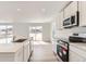 Open-concept kitchen boasting stainless steel appliances, quartz countertops, and plenty of cabinet space at 22036 E 39Th Pl, Aurora, CO 80019