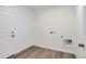 Spacious laundry room with wood floors and utility connections at 22036 E 39Th Pl, Aurora, CO 80019