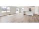 Bright and airy living room with wood floors, large windows, and sliding doors to the backyard at 22036 E 39Th Pl, Aurora, CO 80019