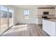 Bright living space featuring sleek wood floors and sliding glass doors for plenty of natural light at 22036 E 39Th Pl, Aurora, CO 80019