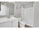Bathroom with a white vanity, toilet, and a shower is modern and elegant at 14473 E Jewell Ave # 202, Aurora, CO 80012