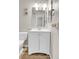 Bathroom with a white vanity, matching mirror, and modern fixtures is stylish and clean at 14473 E Jewell Ave # 202, Aurora, CO 80012