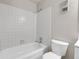 Bathroom with a white shower-tub combo and toilet is perfect for relaxation at 14473 E Jewell Ave # 202, Aurora, CO 80012