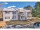Charming condo with stone chimney, second-story balconies, manicured lawn, and car in the parking lot at 14473 E Jewell Ave # 202, Aurora, CO 80012