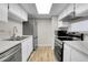 Updated kitchen features stainless steel appliances, white cabinets, and a stylish undermount sink at 14473 E Jewell Ave # 202, Aurora, CO 80012