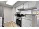 Updated kitchen with new stainless steel appliances and white cabinets at 14473 E Jewell Ave # 202, Aurora, CO 80012