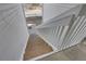 Exterior wood staircase with white railings and stone landing providing access to upper-level apartments at 14473 E Jewell Ave # 202, Aurora, CO 80012