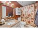 Charming bathroom with wood-framed mirror, cabinet storage and earthy tones for a warm feel at 8408 Everett Way # B, Arvada, CO 80005