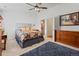 Comfortable bedroom with an ensuite bath features a dresser, a bed and an area rug at 8408 Everett Way # B, Arvada, CO 80005