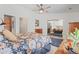 Bright bedroom features a mirrored closet, a dresser and vibrant flower-patterned bedding at 8408 Everett Way # B, Arvada, CO 80005