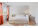 Inviting bedroom with white daybed, natural light and colorful decorative rug at 8408 Everett Way # B, Arvada, CO 80005