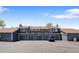 Townhome exterior showcasing multi-car garages and second-story patios under a sunny sky at 8408 Everett Way # B, Arvada, CO 80005