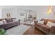 Spacious living room with hardwood floors seamlessly connected to the dining area and kitchen at 8408 Everett Way # B, Arvada, CO 80005