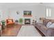 Comfortable living area with a fireplace, plush seating, and abundant natural light at 8408 Everett Way # B, Arvada, CO 80005