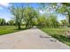 Picturesque walking path lined with mature trees in the Arvada Volunteer Fire Fighters Park at 8408 Everett Way # B, Arvada, CO 80005