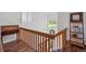 Bright staircase landing with hardwood floors, natural light, and decorative shelving at 8408 Everett Way # B, Arvada, CO 80005