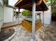 Backyard area showcasing a covered hot tub, brick-paved patio, and a glimpse of the wooden deck at 2720 E 121St Pl, Thornton, CO 80241