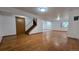 Spacious basement area with hardwood floors, stairs to the upper level, and ample lighting at 2720 E 121St Pl, Thornton, CO 80241
