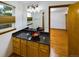 Well-lit bathroom features a vessel sink, granite countertop, and a view into the bedroom at 2720 E 121St Pl, Thornton, CO 80241
