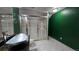 Unique bathroom features dark green walls, a glass shower, and a modern vessel sink at 2720 E 121St Pl, Thornton, CO 80241