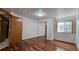 Bedroom featuring hardwood floors, closet with mirrored doors, and a window at 2720 E 121St Pl, Thornton, CO 80241