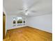 Spacious bedroom features hardwood floors, a ceiling fan, and large windows offering plenty of natural light at 2720 E 121St Pl, Thornton, CO 80241