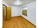 Bedroom boasts wood floors, a large window, and an adjacent bathroom at 2720 E 121St Pl, Thornton, CO 80241