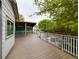 Spacious deck with a partial shade covering and grey-stained wood and white painted railings at 2720 E 121St Pl, Thornton, CO 80241