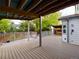 View of a large, well-maintained wooden deck overlooking the yard, featuring a covered hot tub area at 2720 E 121St Pl, Thornton, CO 80241