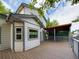 Exterior view of a house with wood siding, a wooden deck, and a covered patio area at 2720 E 121St Pl, Thornton, CO 80241