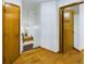 Hallway with wood floors leading to carpeted stairs and multiple rooms, providing a sense of flow at 2720 E 121St Pl, Thornton, CO 80241