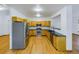 Bright kitchen featuring stainless appliances, dark countertops and hardwood flooring, offering a modern look at 2720 E 121St Pl, Thornton, CO 80241