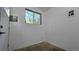 A bright room with a window and an exterior door, features unfinished flooring at 2720 E 121St Pl, Thornton, CO 80241