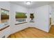 Cozy sitting area with wood floors, bright natural light, and three windows at 2720 E 121St Pl, Thornton, CO 80241