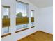 Bright windows with shades offer natural light in this room with clean white walls and hardwood floors at 2720 E 121St Pl, Thornton, CO 80241