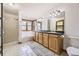 Bright bathroom boasts dual sinks, a soaking tub, a separate shower, and natural wood accents at 538 Sawmill Creek Rd, Evergreen, CO 80439