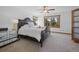 Serene bedroom with plush carpet, king bed, scenic views, and wood trim windows at 538 Sawmill Creek Rd, Evergreen, CO 80439