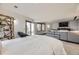 Spacious bedroom with a wrought iron bed frame and a comfortable gray sectional sofa in the adjoining seating area at 538 Sawmill Creek Rd, Evergreen, CO 80439