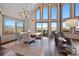 Elegant dining room with large windows, a rustic wooden table, and mountain views at 538 Sawmill Creek Rd, Evergreen, CO 80439