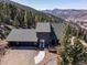 Beautiful exterior shot of mountain home with stunning view, roof, and a three car garage at 538 Sawmill Creek Rd, Evergreen, CO 80439