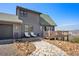Beautiful home with a stone pathway, wooden deck, and mountain views at 538 Sawmill Creek Rd, Evergreen, CO 80439