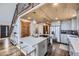 Open concept kitchen with island, stainless steel appliances and unique wooden ceiling at 538 Sawmill Creek Rd, Evergreen, CO 80439