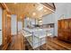 Stunning kitchen features a large island with seating, custom cabinets, and modern lighting fixtures at 538 Sawmill Creek Rd, Evergreen, CO 80439