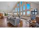 Spacious living room featuring floor-to-ceiling windows with stunning views and hardwood floors at 538 Sawmill Creek Rd, Evergreen, CO 80439