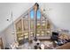 Spacious living room with vaulted ceilings, a wall of windows, a wood burning stove, and mountain views at 538 Sawmill Creek Rd, Evergreen, CO 80439
