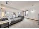 Open living area featuring a sectional sofa, plush carpeting, and natural lighting at 538 Sawmill Creek Rd, Evergreen, CO 80439