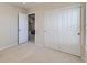 Bedroom with neutral walls, carpet floors, closet, and open door to another room at 9435 E 108Th Pl, Commerce City, CO 80640