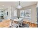 Bright dining area featuring hardwood floors, white table set, and natural light, providing a cozy meal setting at 9435 E 108Th Pl, Commerce City, CO 80640